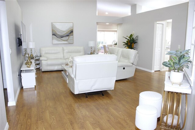 living area with wood finished floors and baseboards