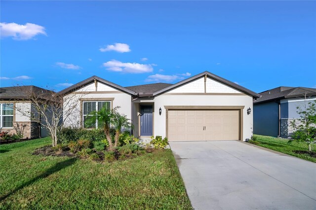 single story home featuring a garage and a front yard