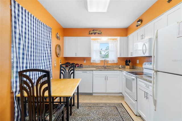 kitchen with white cabinetry, white appliances, sink, and light stone counters