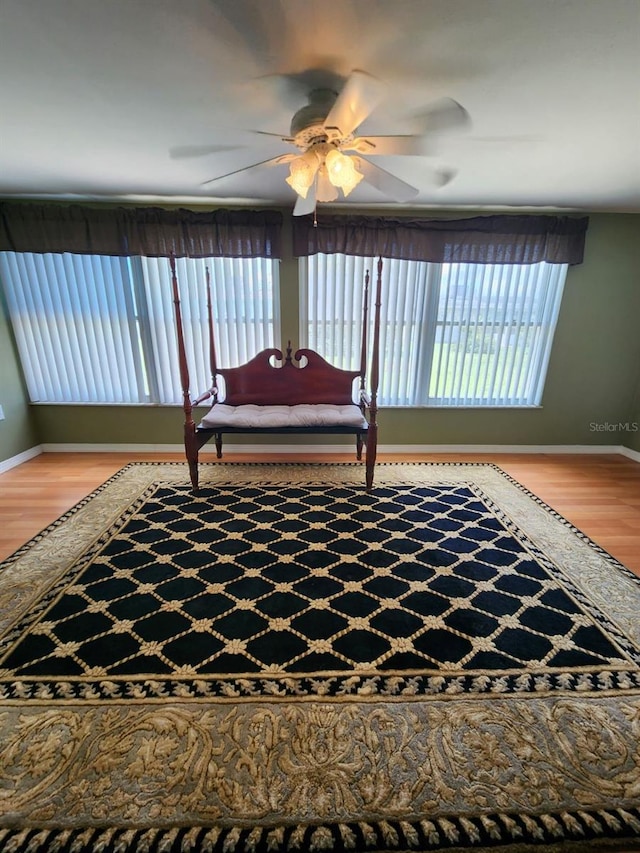 living area featuring ceiling fan and hardwood / wood-style floors