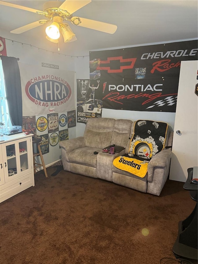 living room featuring ceiling fan and dark carpet