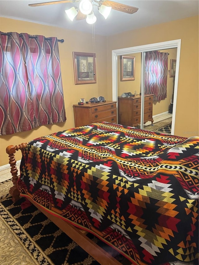 bedroom with ceiling fan and a closet