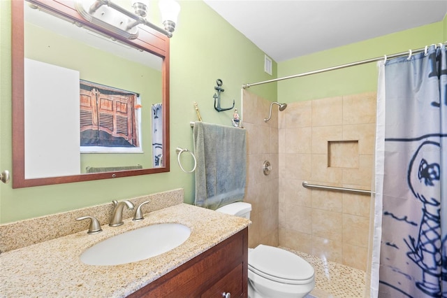 bathroom with vanity, curtained shower, and toilet