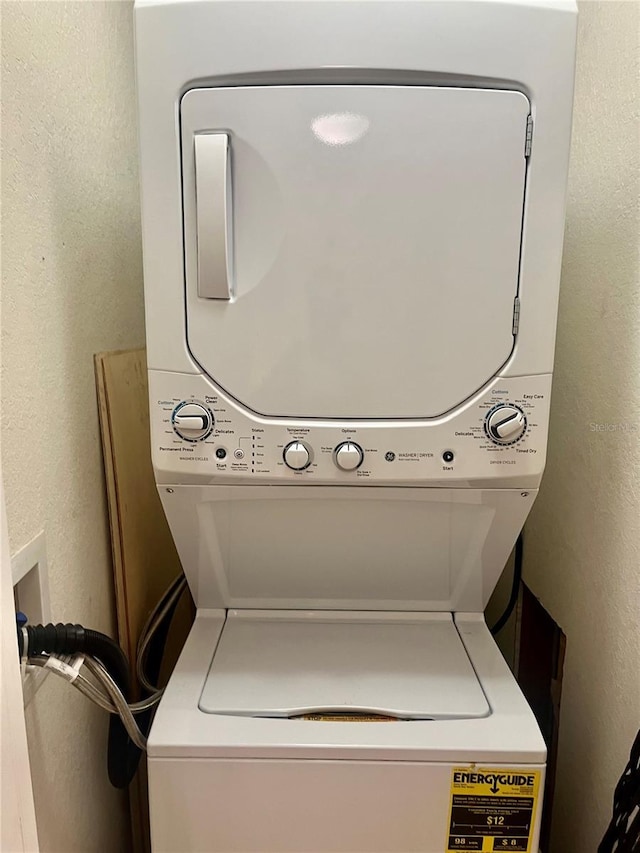 washroom with stacked washer / drying machine