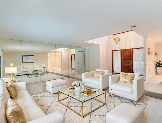 carpeted living room featuring a chandelier