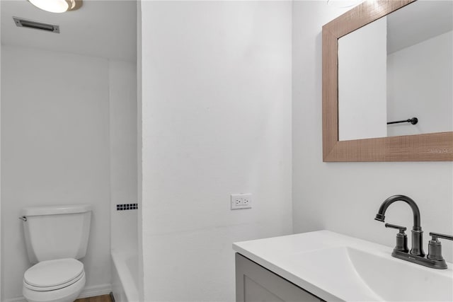 bathroom featuring toilet, visible vents, and vanity