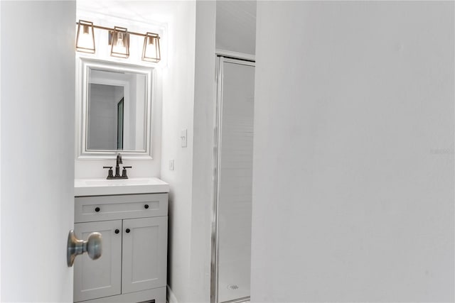 bathroom featuring a shower stall and vanity