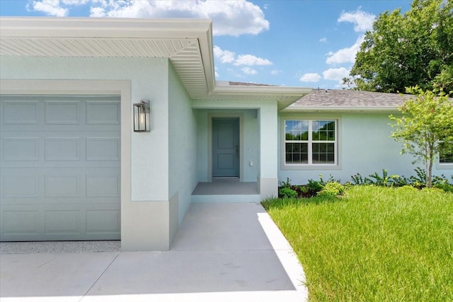 property entrance featuring a garage and a yard