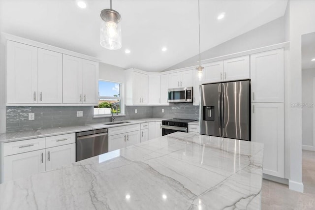 kitchen featuring white cabinetry, hanging light fixtures, decorative backsplash, light stone counters, and appliances with stainless steel finishes