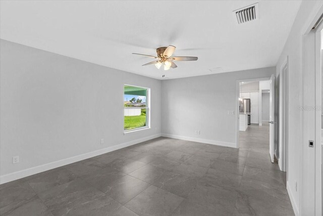 tiled empty room with ceiling fan