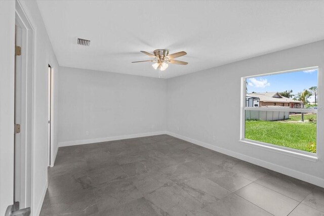 tiled empty room with ceiling fan