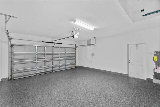 garage featuring water heater and a garage door opener