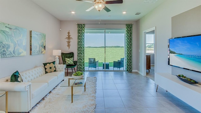 tiled living room featuring ceiling fan