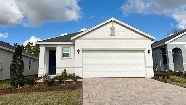 4067 NW 44th Cir, Ocala, FL 34482 - single story home with decorative driveway, stucco siding, and a garage
