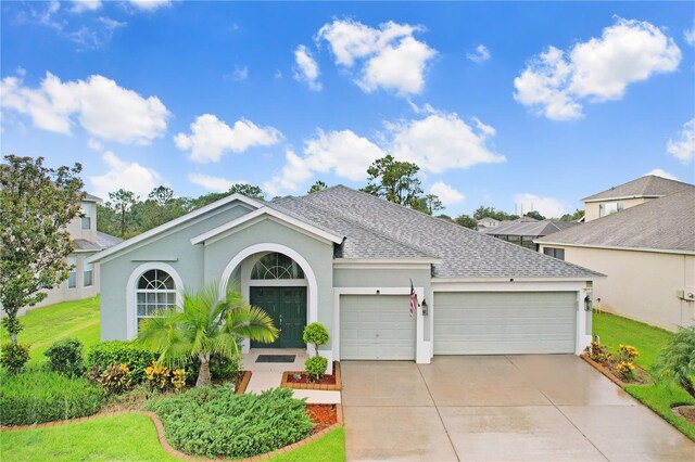 ranch-style house featuring a garage and a front yard