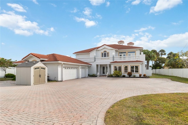 mediterranean / spanish house featuring a storage unit, covered porch, and a balcony