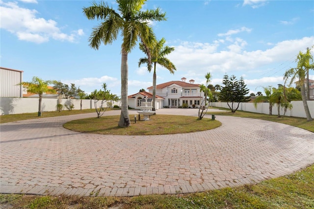 mediterranean / spanish-style home with a front yard and a garage