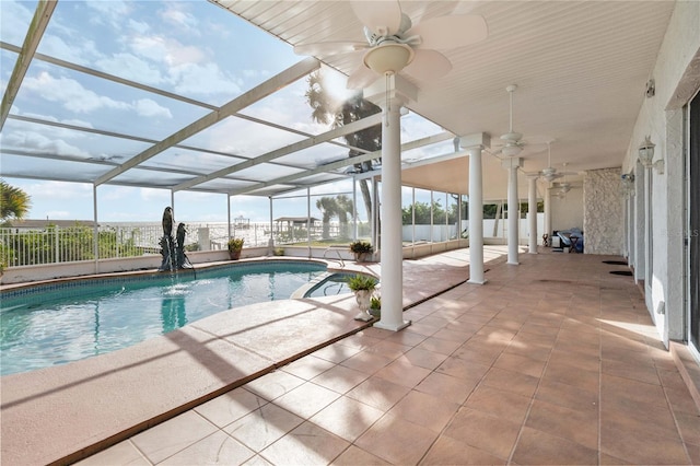 view of pool featuring a patio, pool water feature, a lanai, and ceiling fan