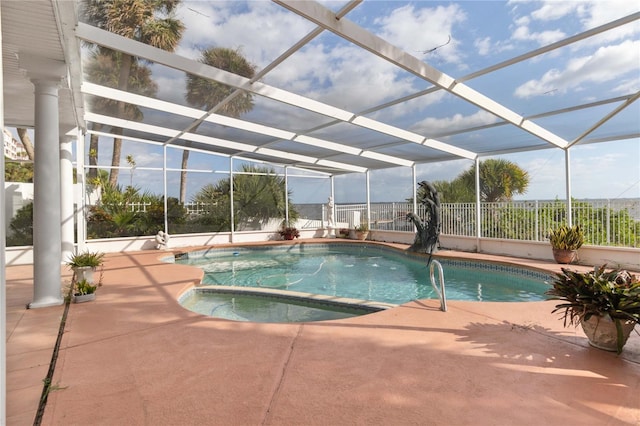 view of swimming pool featuring a patio area and a lanai