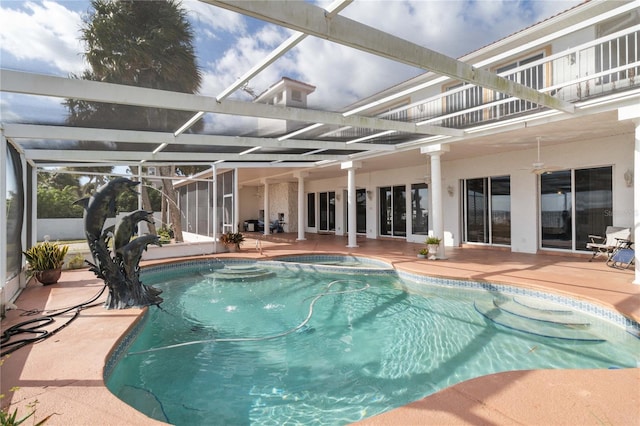 view of pool with a patio, an in ground hot tub, and glass enclosure