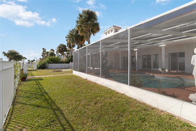 view of yard with a fenced in pool, a patio, and glass enclosure