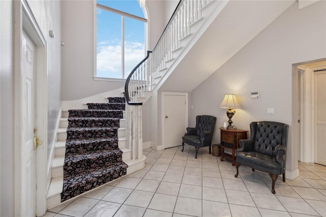 interior space with a high ceiling and light tile patterned floors