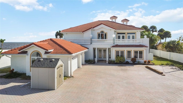 back of property featuring a balcony and a garage