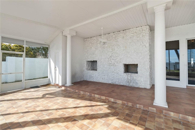 exterior space with ornate columns and vaulted ceiling