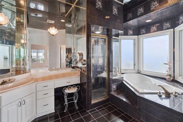 bathroom featuring vanity, independent shower and bath, and tile patterned floors