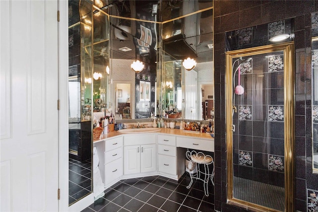 bathroom featuring vanity, an enclosed shower, and tile patterned floors