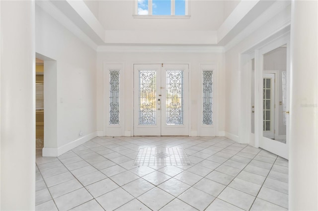 empty room featuring french doors, light tile patterned flooring, and a healthy amount of sunlight