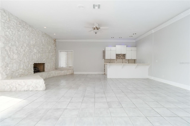 unfurnished living room with crown molding, light tile patterned floors, a fireplace, and ceiling fan