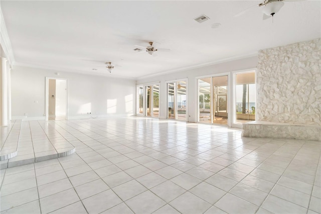 tiled empty room featuring ceiling fan and ornamental molding