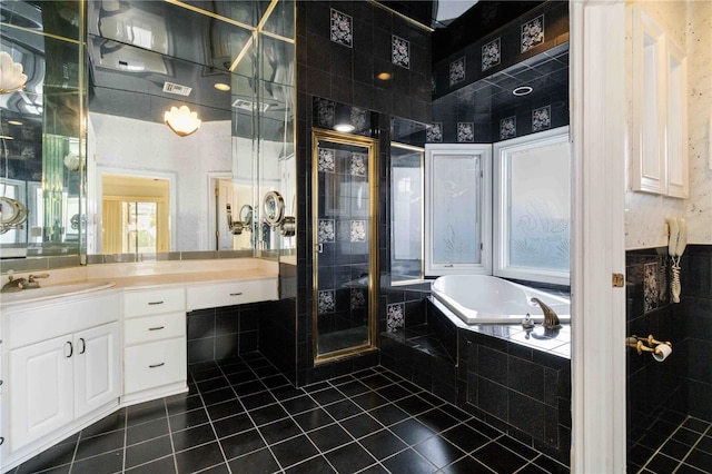 bathroom featuring vanity, shower with separate bathtub, and tile patterned floors