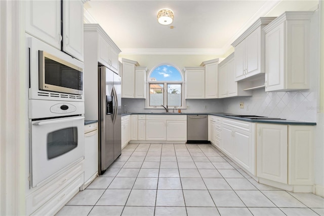 kitchen featuring stainless steel appliances and white cabinets