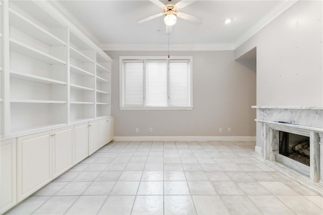 unfurnished living room with a fireplace, ornamental molding, light tile patterned flooring, built in shelves, and ceiling fan