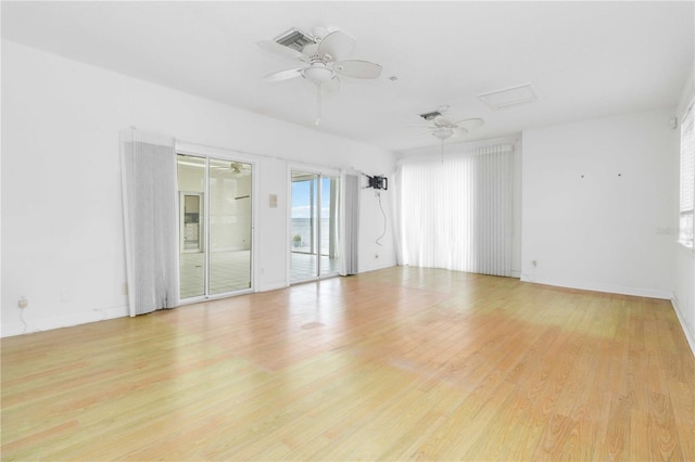 empty room featuring ceiling fan and light wood-type flooring