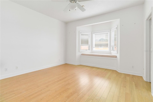 empty room featuring ceiling fan and light wood-type flooring