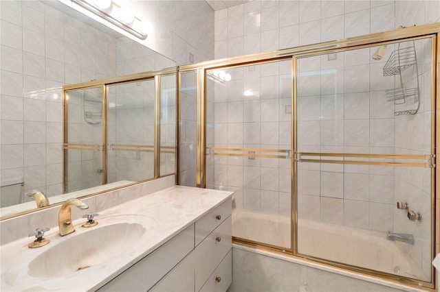 bathroom featuring vanity and shower / bath combination with glass door