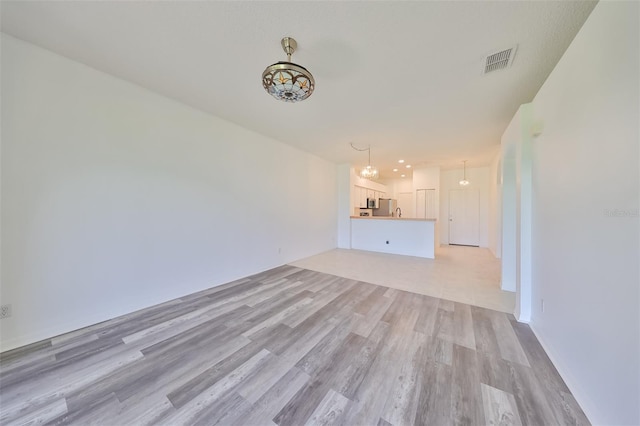 unfurnished living room with light hardwood / wood-style floors