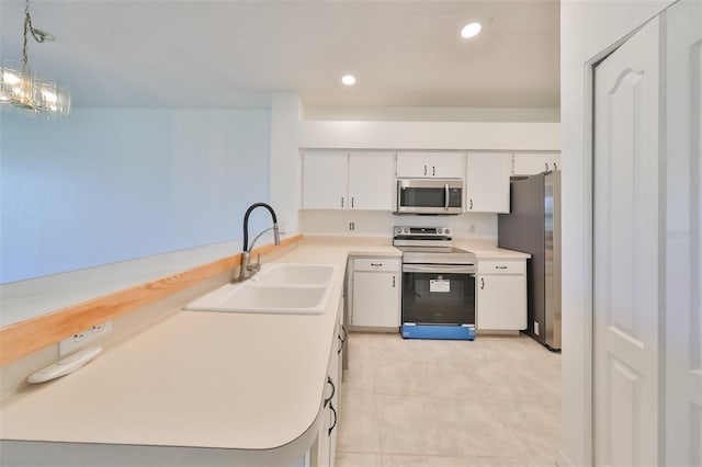 kitchen featuring pendant lighting, white cabinetry, sink, a notable chandelier, and stainless steel appliances