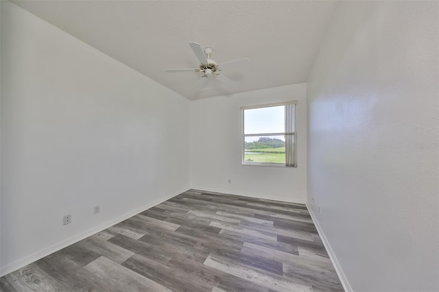 empty room featuring lofted ceiling, a textured ceiling, ceiling fan, and light wood-type flooring