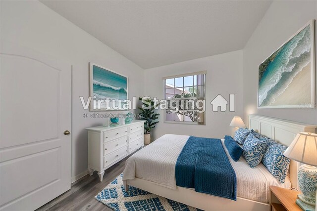 633 Tremont Greens Ln Unit 16, Sun City Center, FL 33573 - bedroom featuring wood finished floors and baseboards