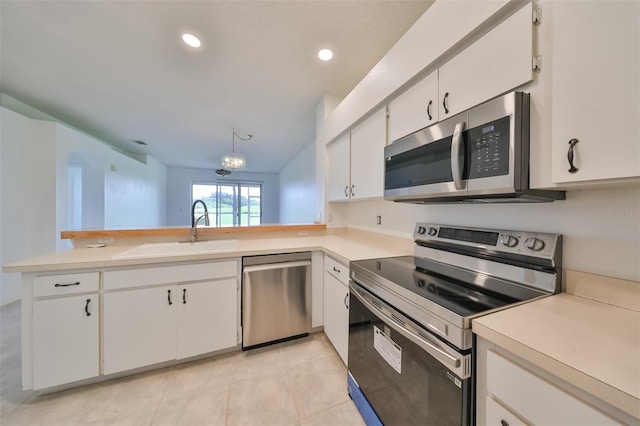 kitchen with white cabinetry, appliances with stainless steel finishes, kitchen peninsula, and sink