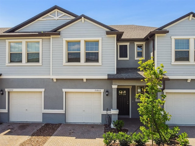 townhome / multi-family property featuring a garage