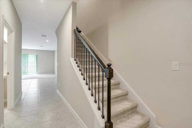 stairs featuring tile patterned flooring