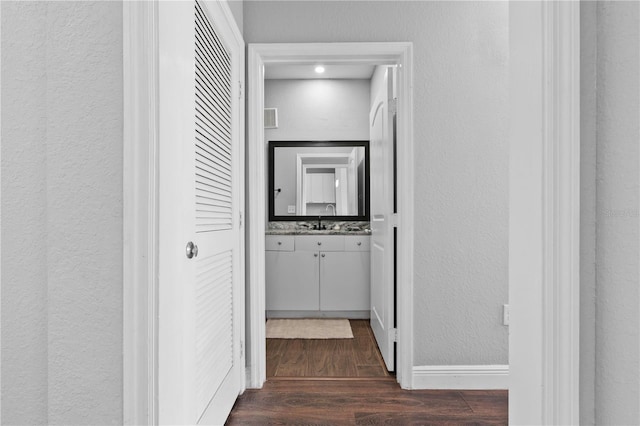 corridor with dark wood-type flooring