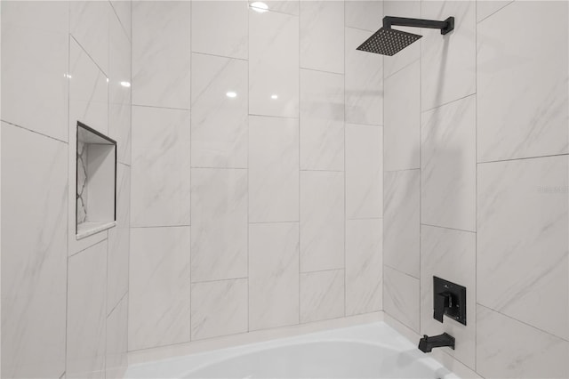 bathroom featuring tiled shower / bath