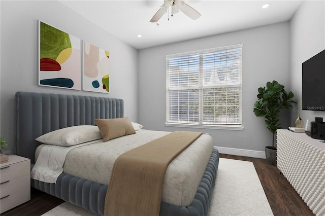 bedroom with ceiling fan and dark hardwood / wood-style flooring