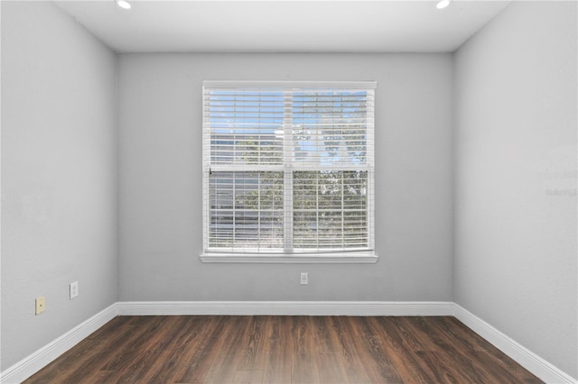 spare room with dark wood-type flooring